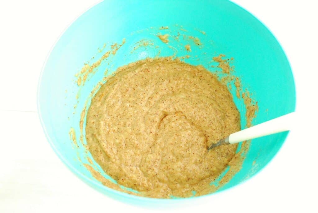 Fully mixed banana muffin batter in a bowl.