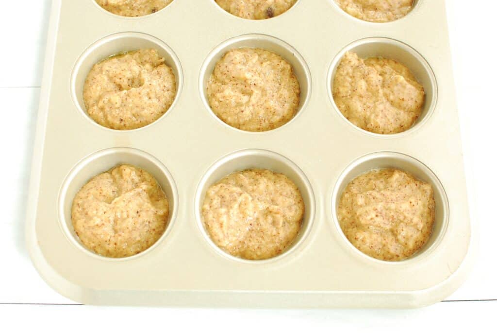 Uncooked batter in a muffin tin.