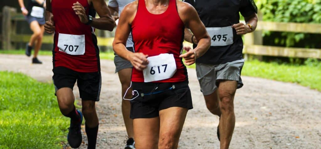 Several runners participating in a 5K road race.