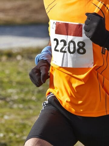 An intermediate 5K runner during a race.