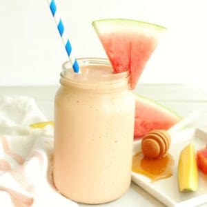 A watermelon protein shake with a slice of watermelon for garnish.