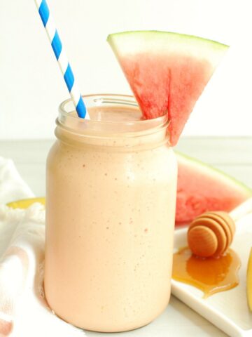 A watermelon protein shake with a slice of watermelon for garnish.