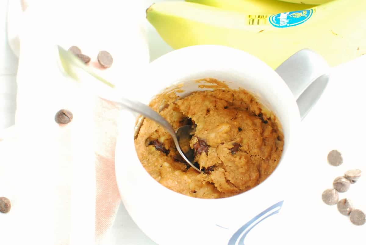 A spoon digging into a healthy banana mug cake.