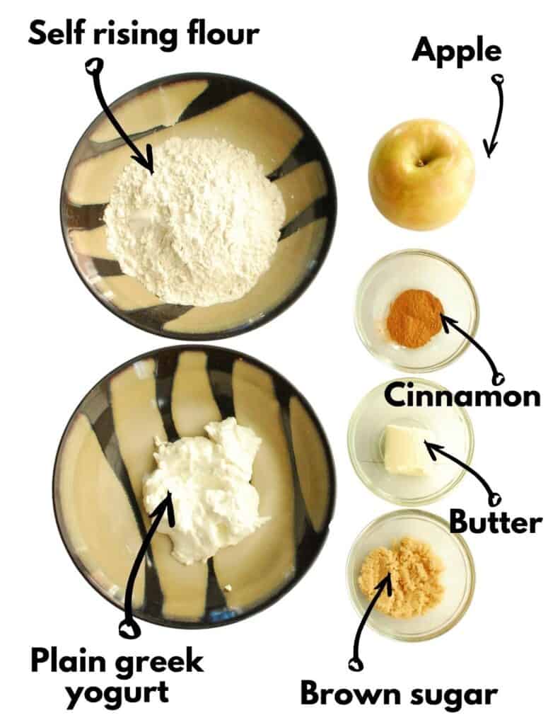 Bowls of greek yogurt, self-rising flour, brown sugar, butter, cinnamon, and an apple.