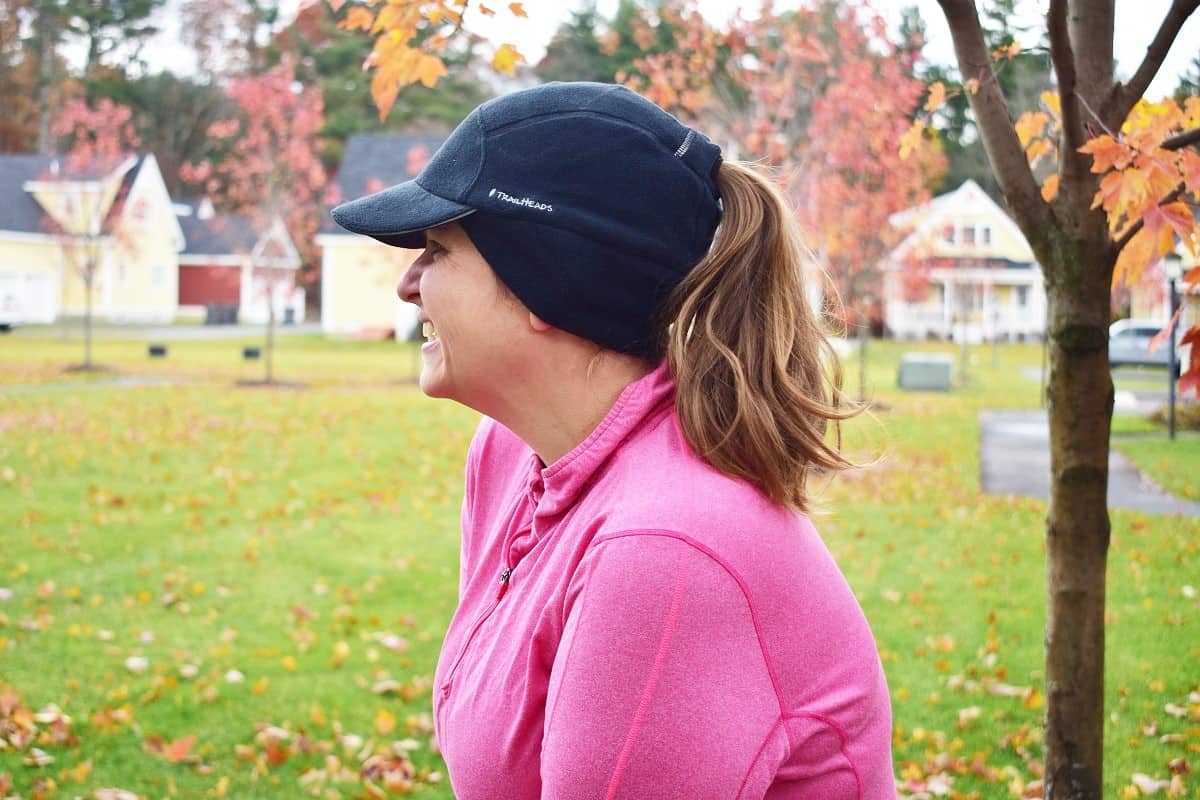 A woman wearing a fleece ponytail hat.