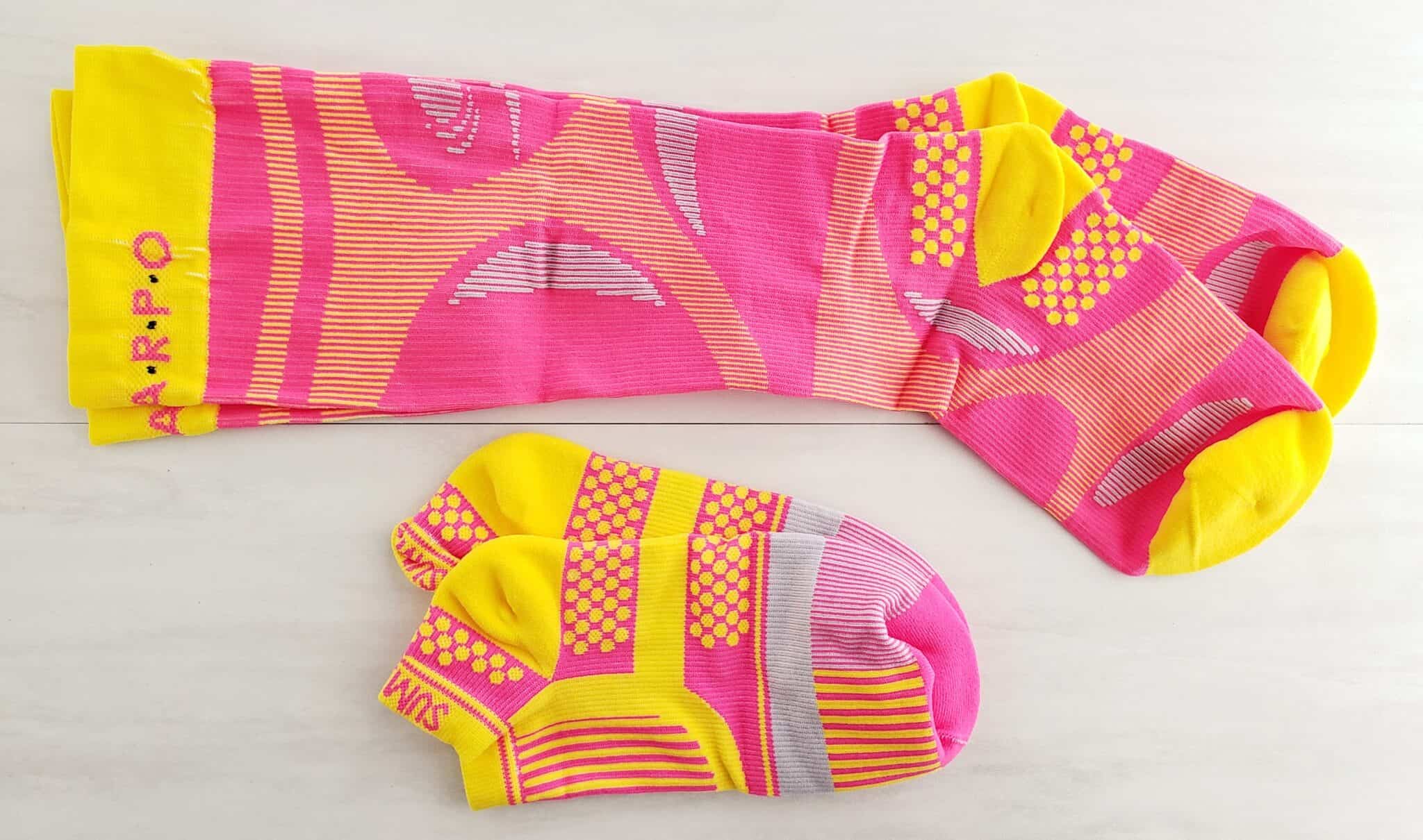 Two pairs of pink compression socks.