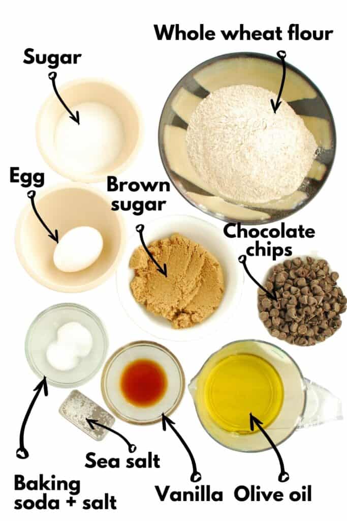 Bowls of ingredients - flour, sugar, brown sugar, egg, baking soda, salt, vanilla, olive oil, and chocolate chips.