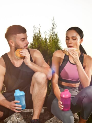 Two runners eating outside in the early evening.