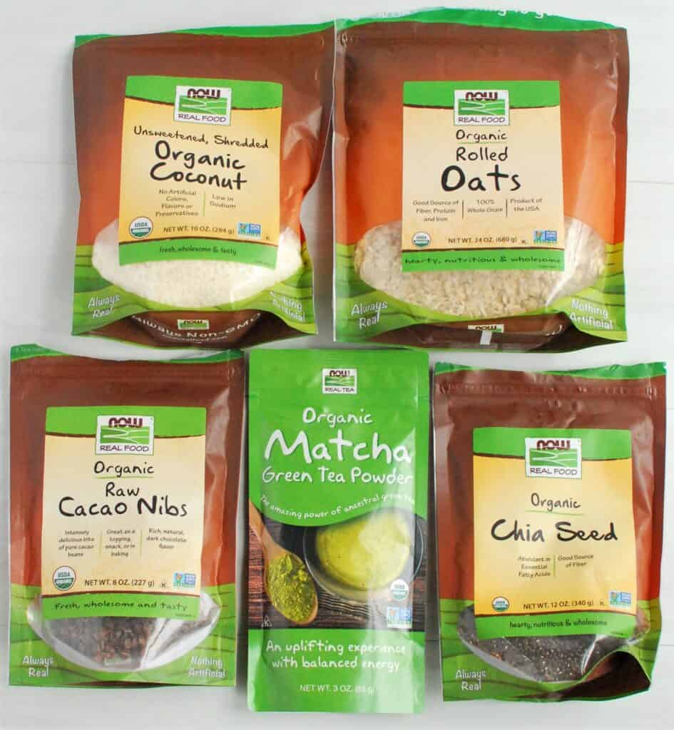 Packages of oats, coconut, chia seeds, cacao nibs, and matcha powder.