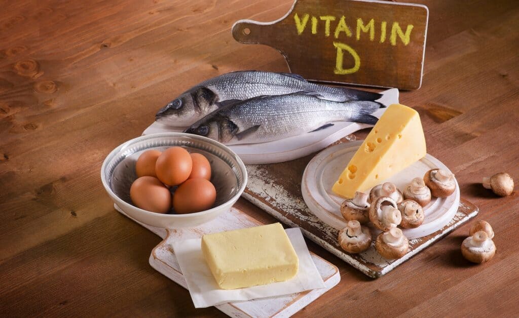 A table with Vitamin D rich foods, including fish, mushrooms, fortified dairy, eggs, and mushrooms.