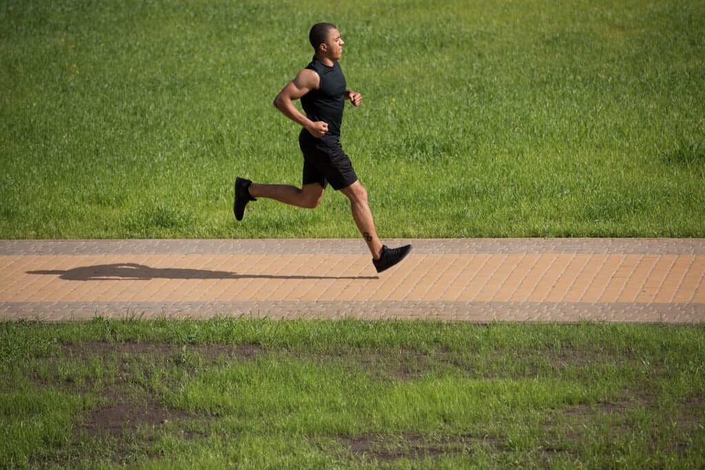 A man running along a path in the park.