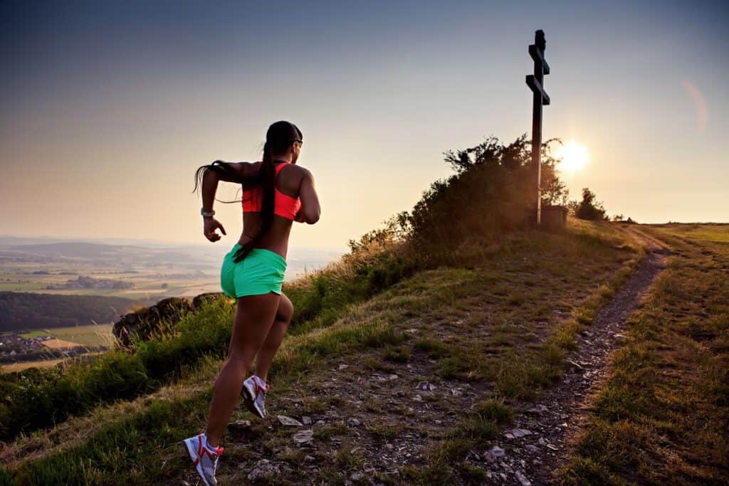 A woman running on a hill.