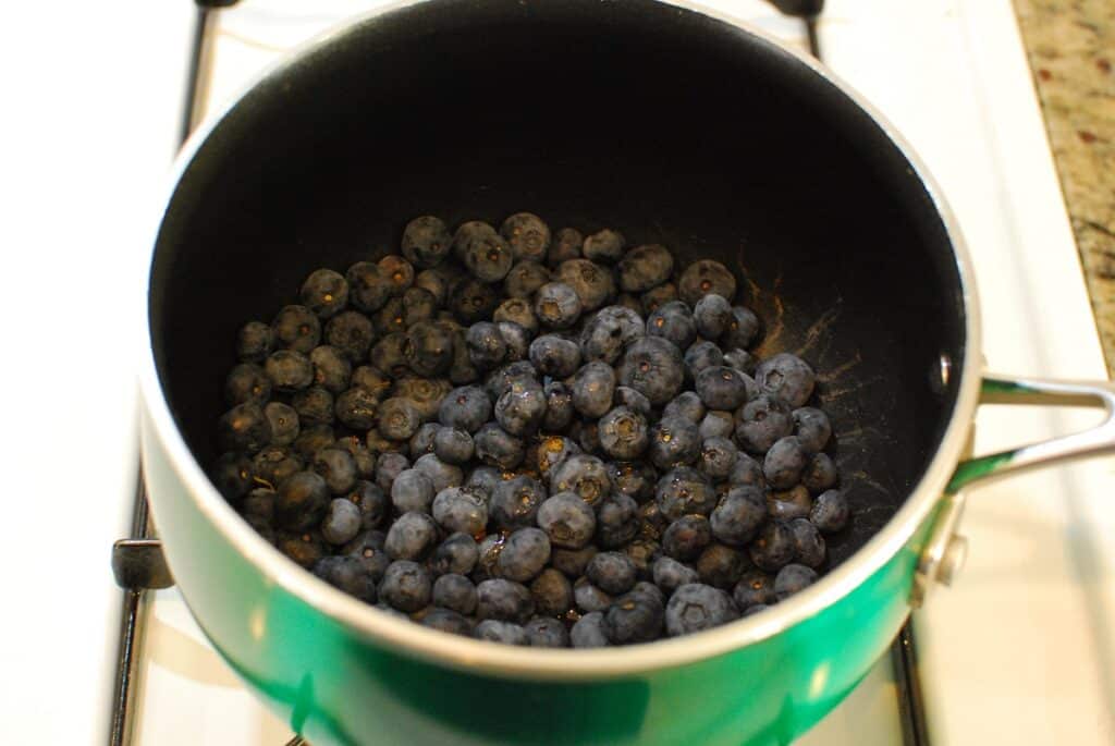 Blueberries and maple syrup in a pot.