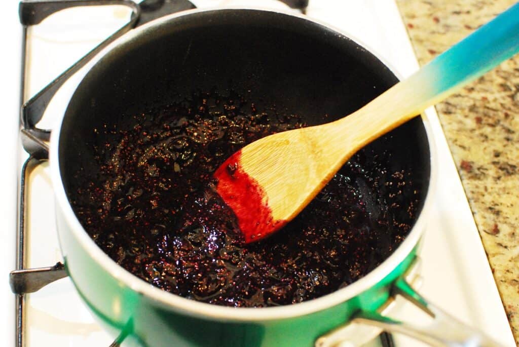 Finished blueberry chia seed jam cooling in a pot.
