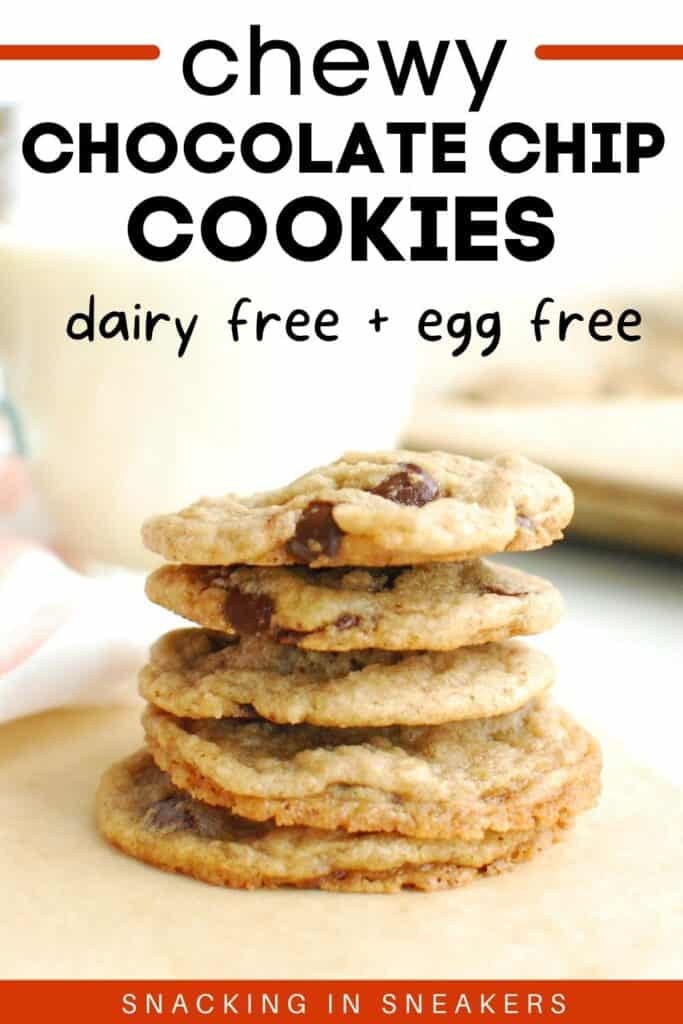 A stack of dairy free egg free chocolate chip cookies with a glass and a baking sheet in the background.