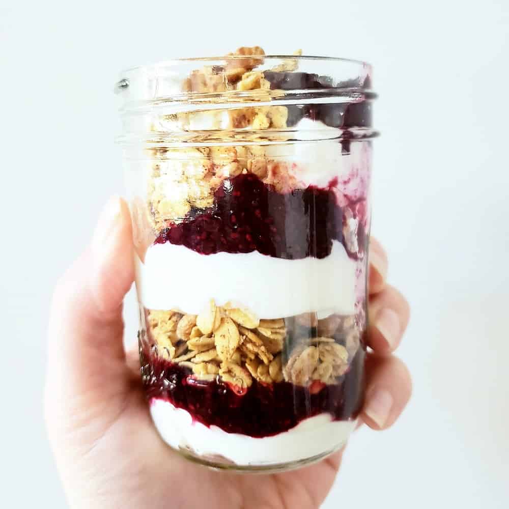 A yogurt parfait with blueberry chia jam and granola.