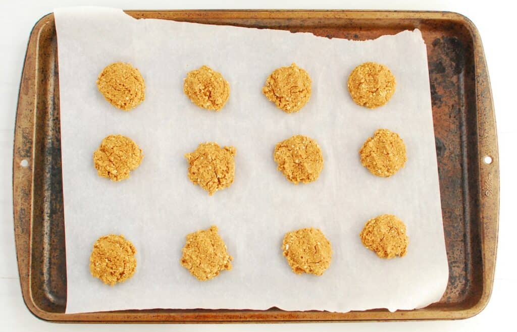 Cooked powdered peanut butter cookies on a baking sheet.