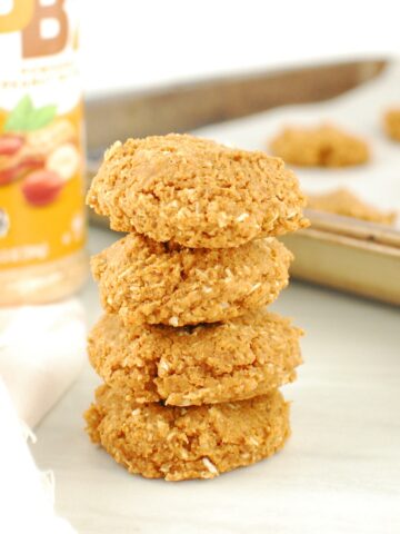 A stack of four powdered peanut butter cookies.