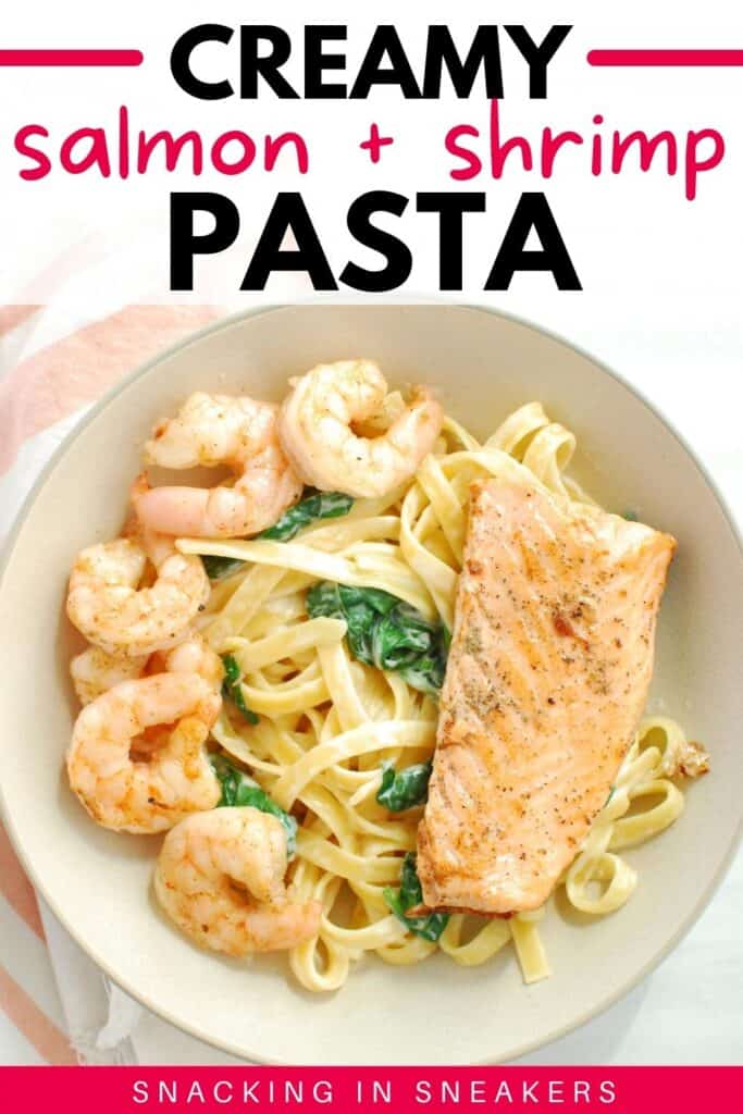 A grey bowl filled with creamy shrimp and salmon pasta.
