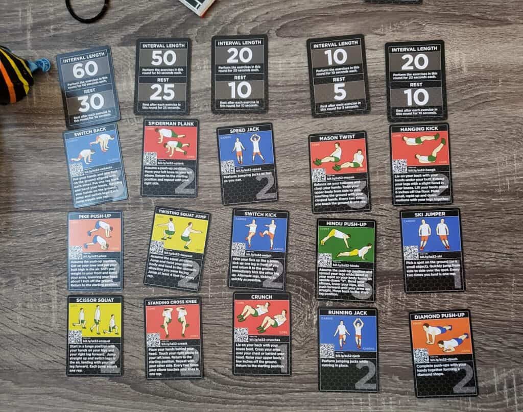 Cards from the HIIT exercise game placed on a table.