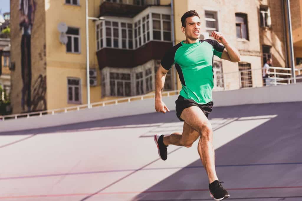 A man running outside near buildings.