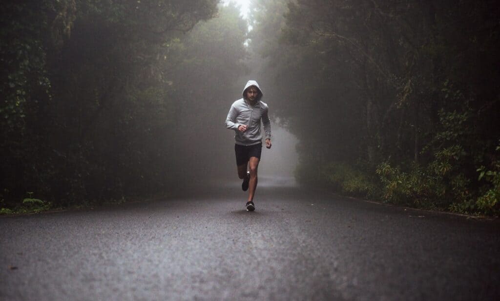 A man running outside on a dreary day.