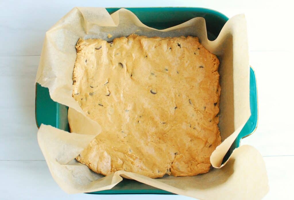 The protein bar mixture pressed into an 8x8 baking dish.