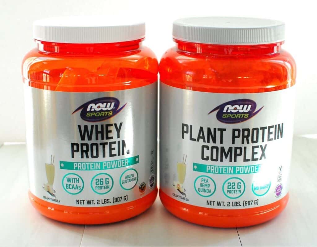 A container of whey protein powder and plant protein powder.
