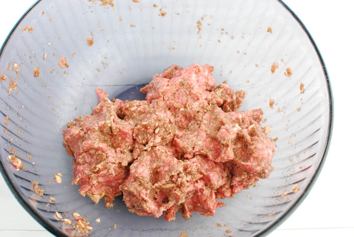 Ground lamb mixture in a mixing bowl.