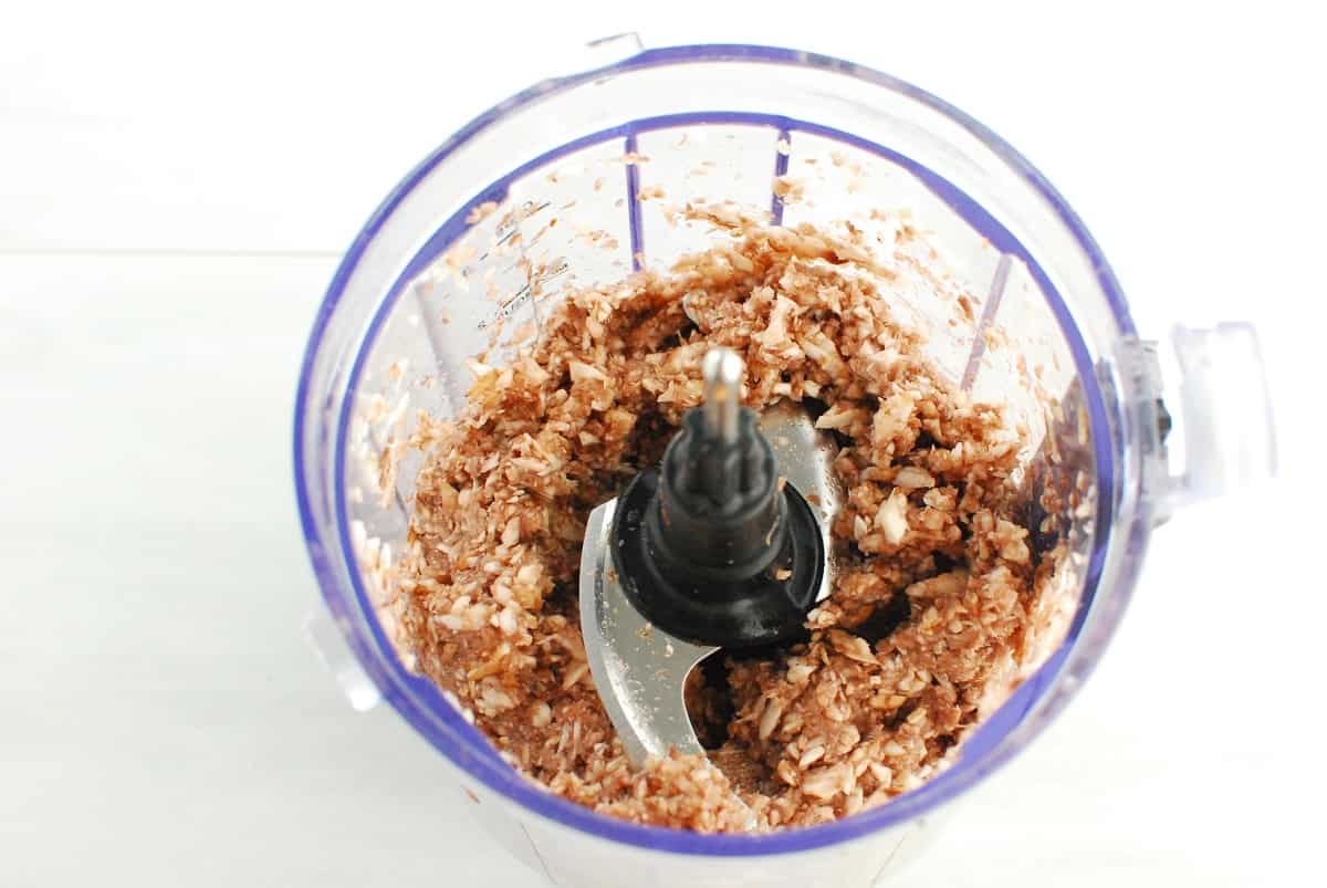 Mushrooms finely chopped in a food processor bowl.