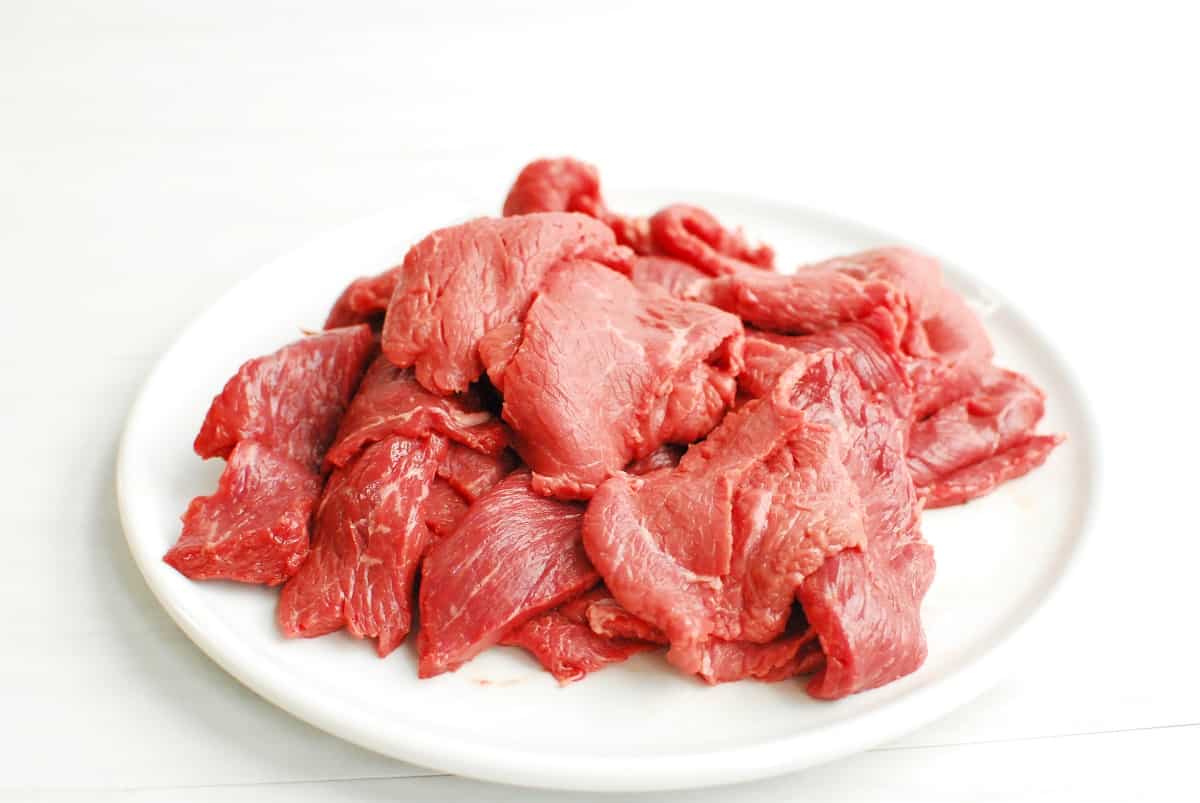 Thinly sliced steak on a plate.