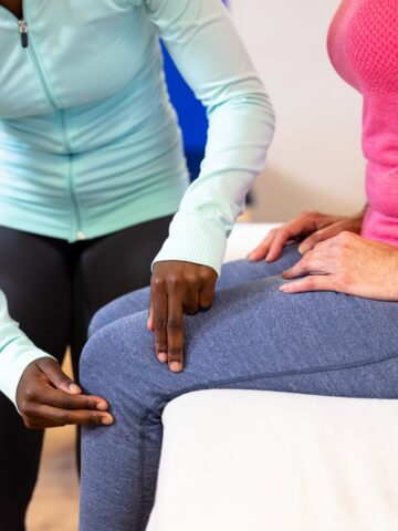 A physical therapist examining a runner's knee.