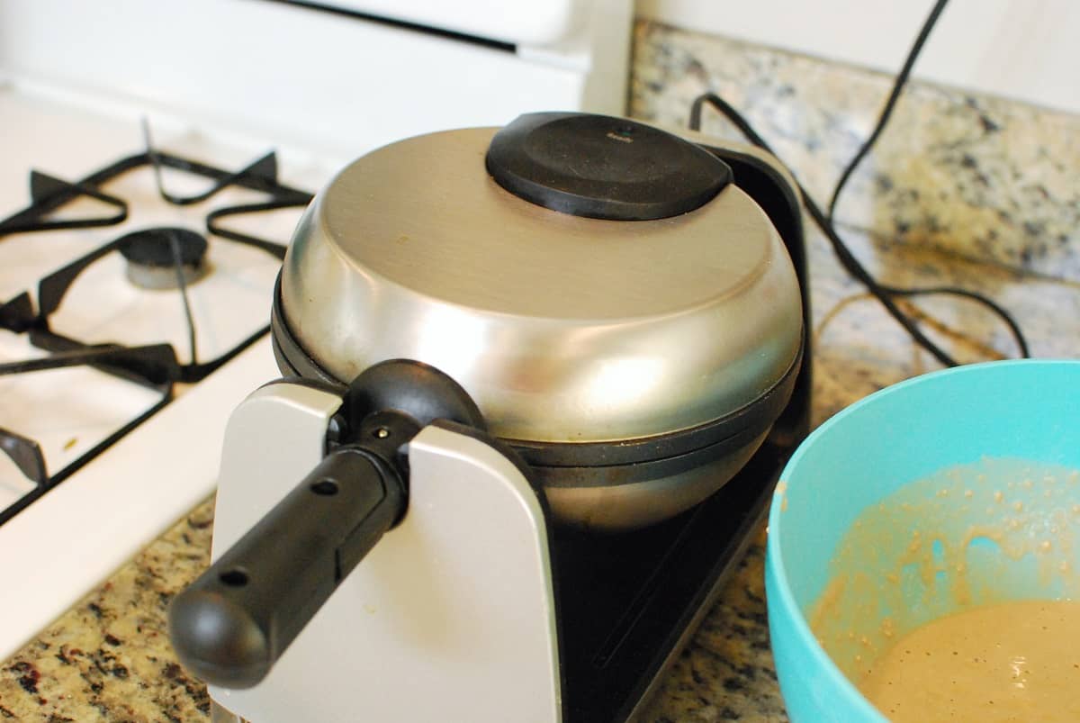 A waffle iron on a kitchen counter.