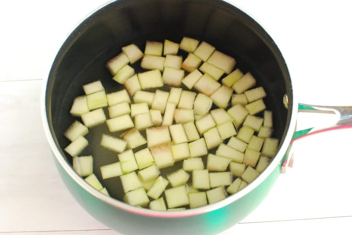 Watermelon rind in a pot with water and sugar.