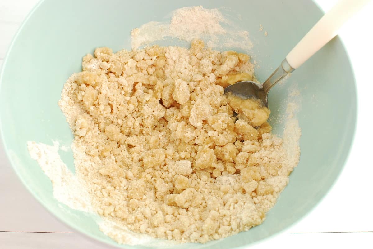 Flour, brown sugar, granulated sugar, and butter mixed together in a bowl.