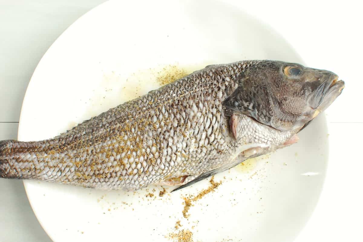 Black sea bass rubbed with oil and seasonings.