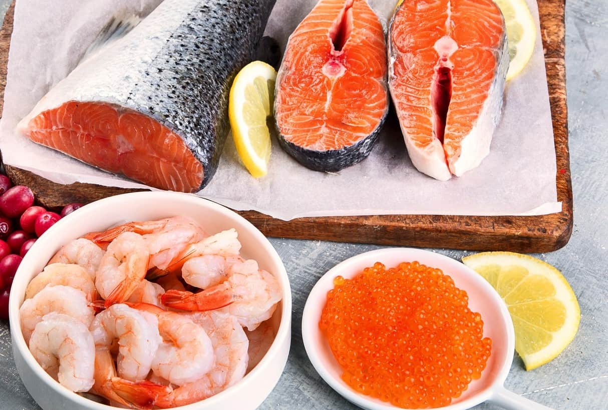 Shrimp, salmon, and salmon roe on a table.