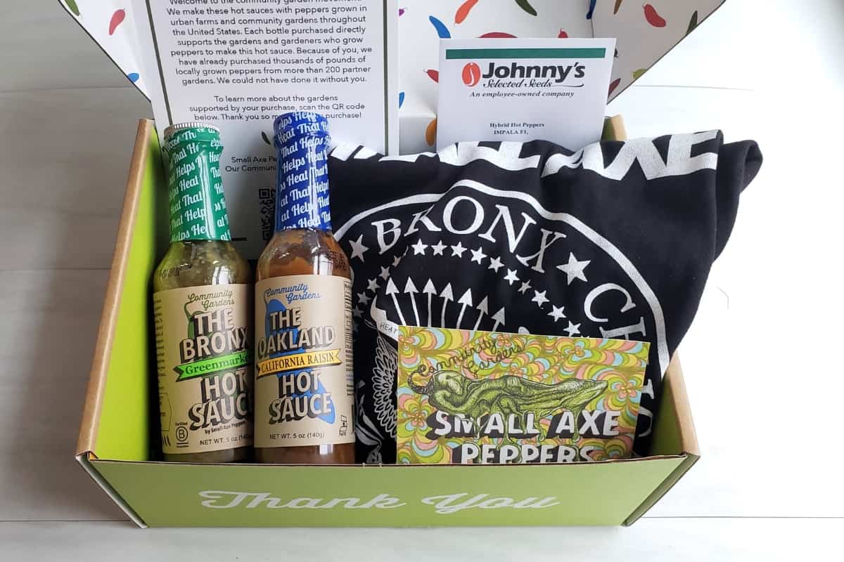 Small Axe Peppers gift set with two hot sauces, a t-shirt, and pepper seeds.