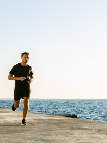 A man running near the waterfront training for an 8K.