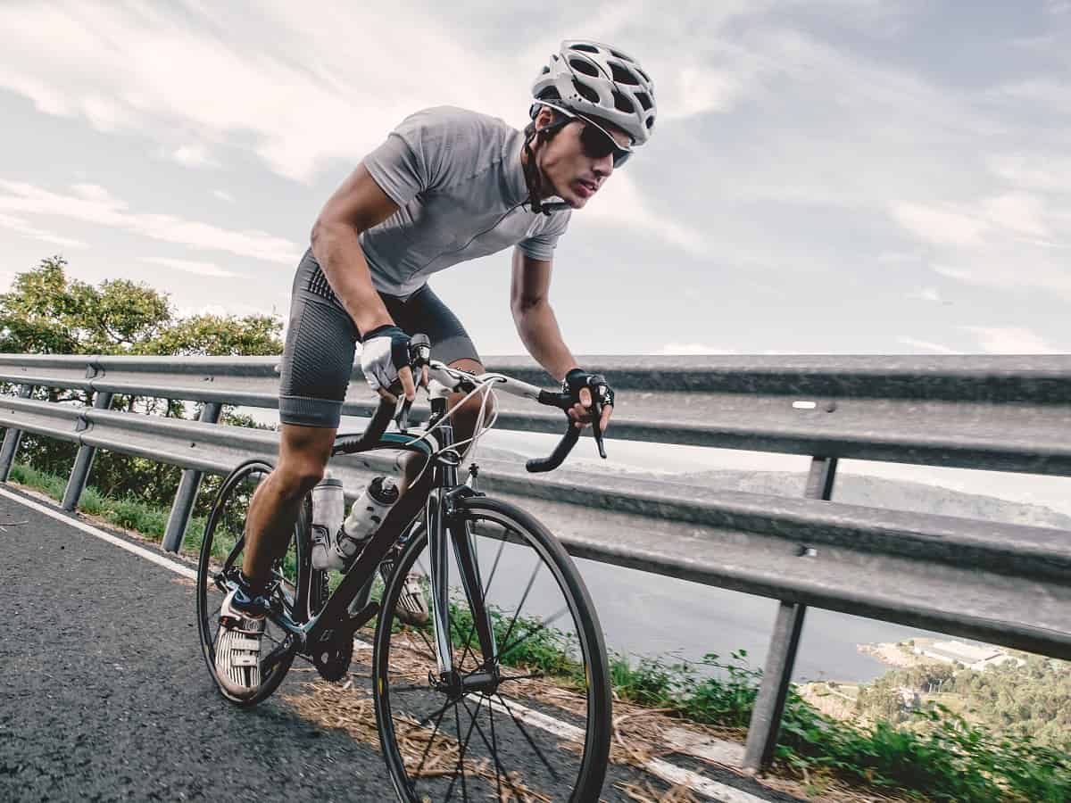 A cyclist dealing with achilles tendonitis while riding.