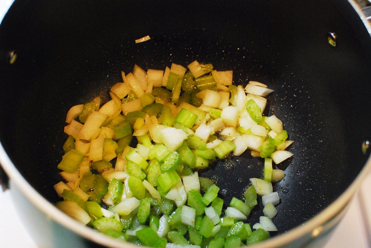 Celery and onion cooking in a pot.