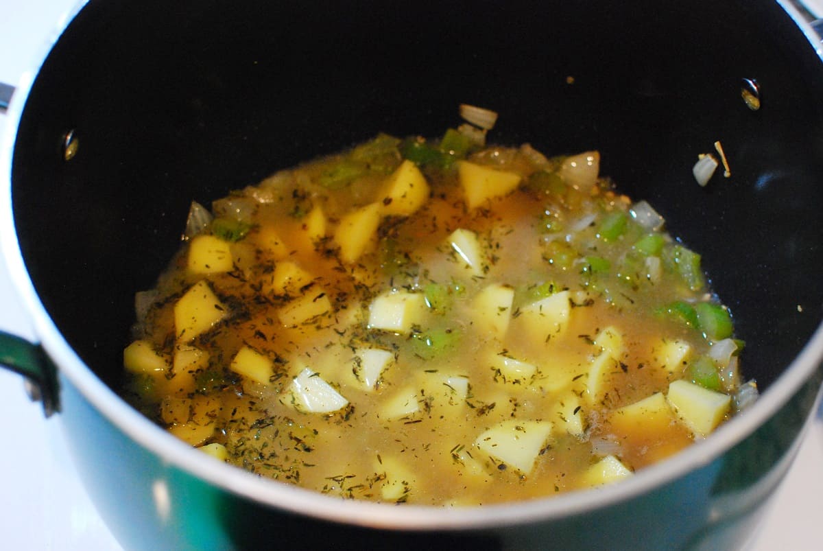 Potatoes and other ingredients in a pot.