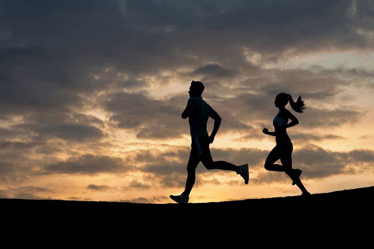 A couple running together at sunrise to beat boredom.