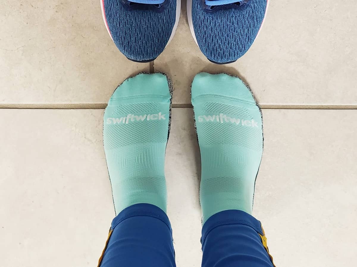 A woman's feet in Swiftwick running socks.