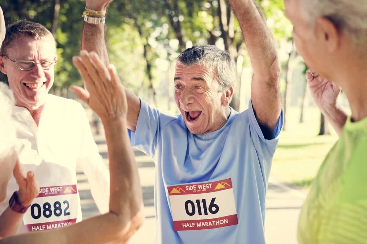 An older man happy to have completed a half marathon.