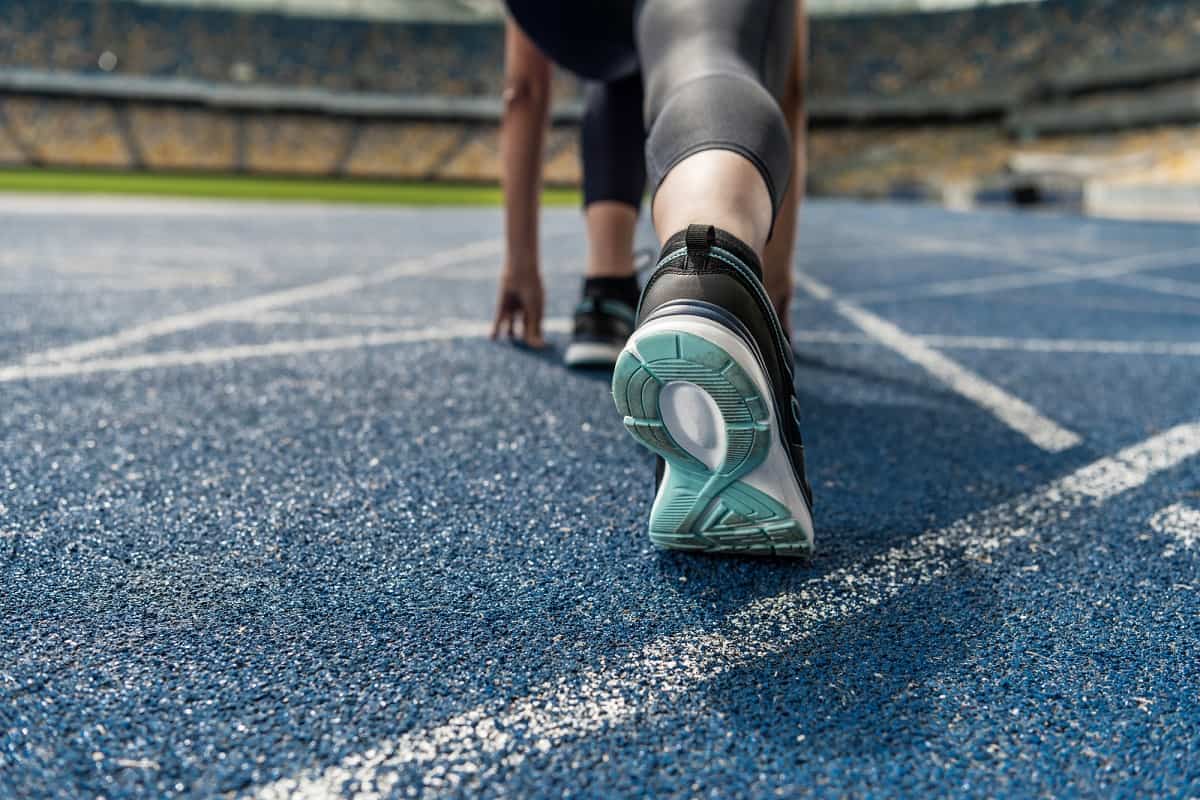 Close up of a runner's sneakers on a track.