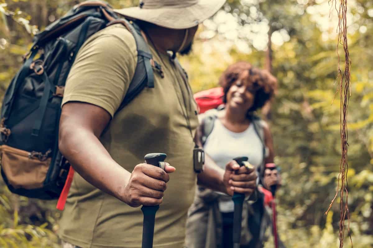 A couple hiking outside during spring for a self care activity.