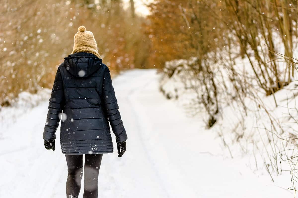 A woman going for a walk outside on a snowy day.