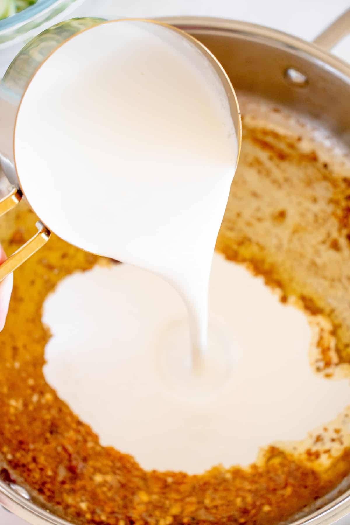 Half and half being poured into the pan.