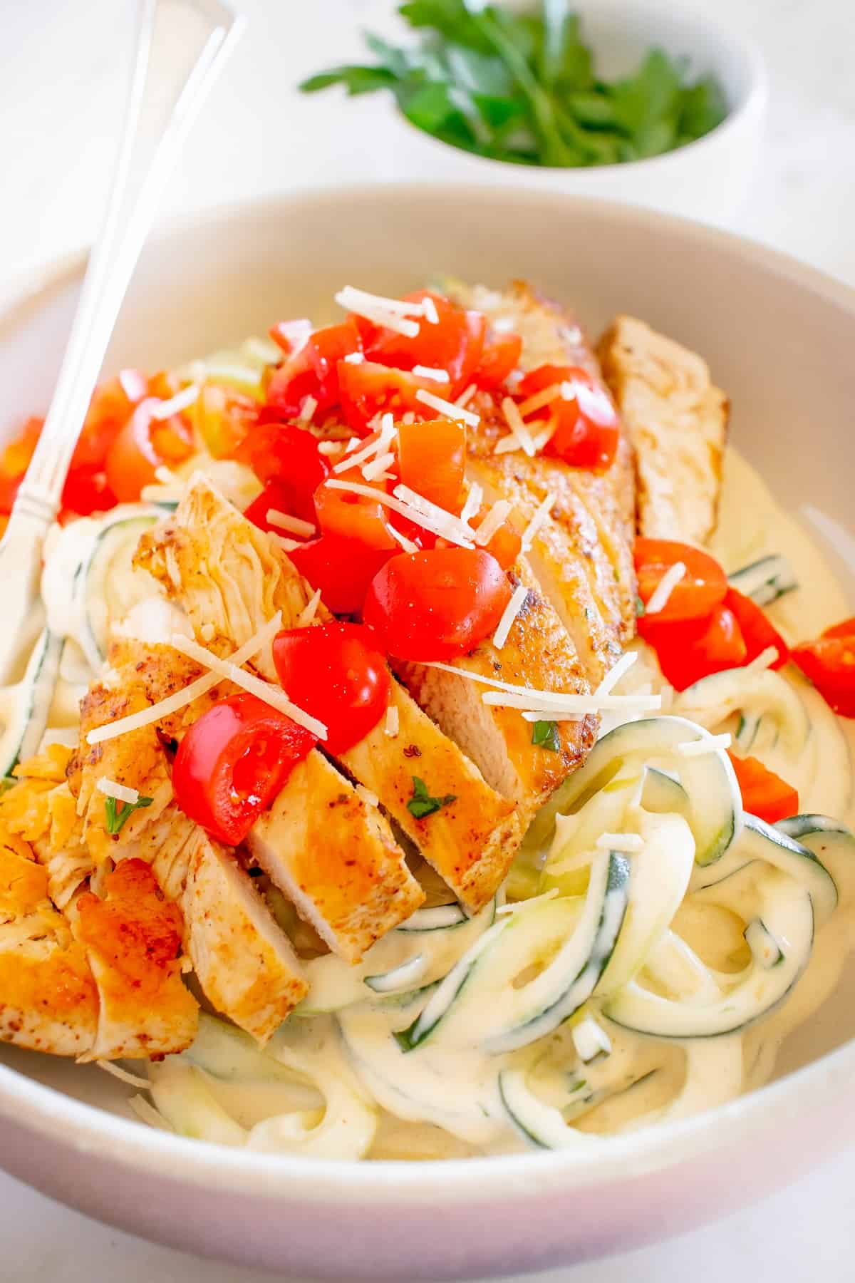 Creamy zoodles with cajun chicken and tomatoes.
